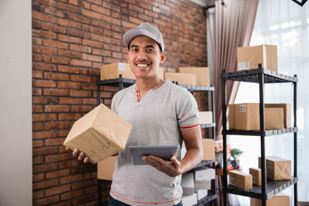 man with tablet pc and packageの写真素材