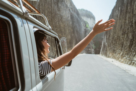 young woman on road trip on the beachの写真素材