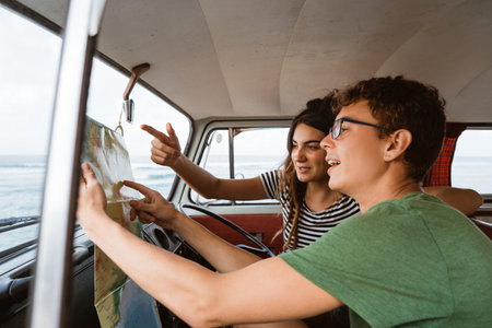 portrait side view of young couple using a map