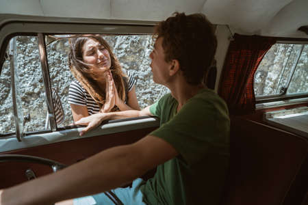 caucasian women hipster hitchhiking asking for helpの写真素材