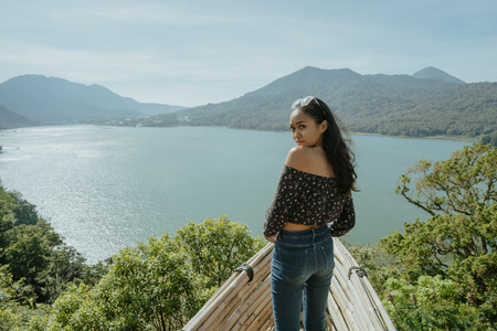 stylish young woman taking picture for social media in natureの写真素材