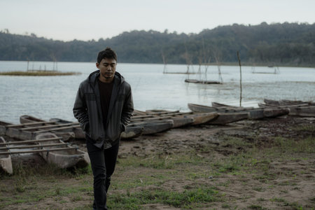 young asian male walking in nature