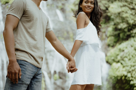lovely couple enjoy banyumala waterfall bali together