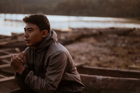 asian young man enjoying the cold morningの写真素材