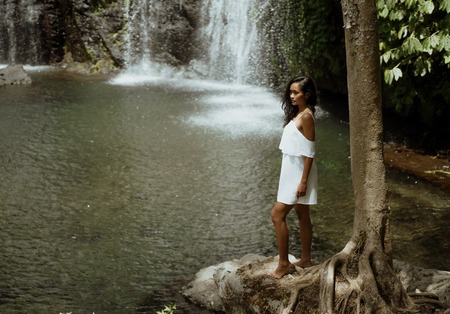 Female tourist enjoying waterfallの写真素材