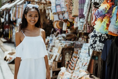 woman walking and looking around at souvenir shopの写真素材