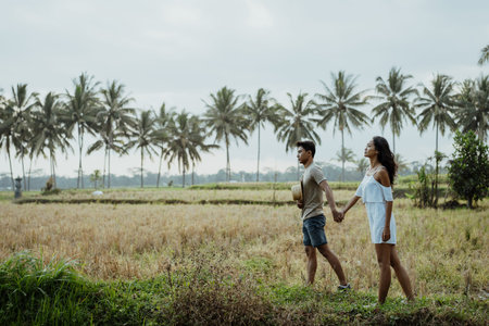 couple stylish walking in rice field together