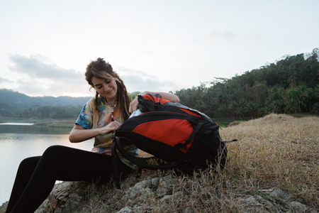 Close up caucasian woman alone sitting side lakeの写真素材
