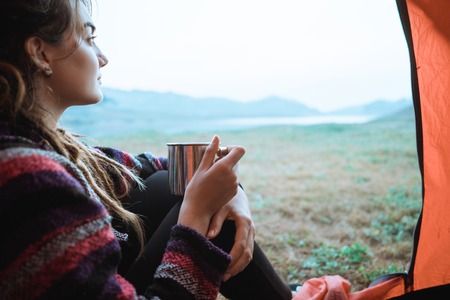 Close up a woman drink a cup of coffee after wake upの写真素材