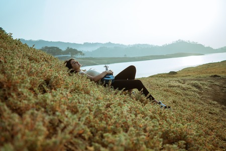 Caucasian women close eyes enjoy and relax side the riverの写真素材