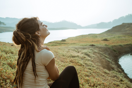A woman enjoys fresh morning airの写真素材