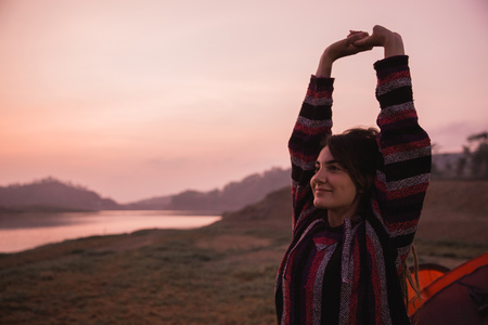 Portrait a beauty woman stretching side a tentの写真素材