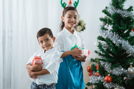 smiling boy and daughter to cameraの写真素材