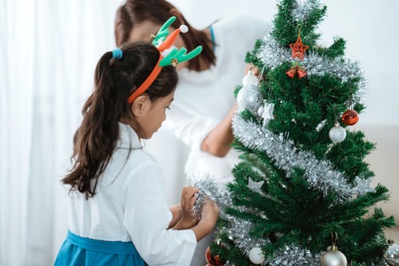 asian family decorate christmas treeの写真素材
