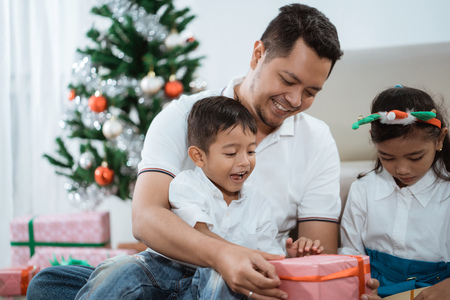 father give his kids a surprise giftの写真素材