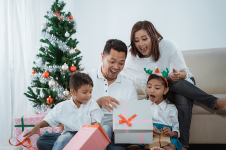 surprise family opening a christmas gifの写真素材