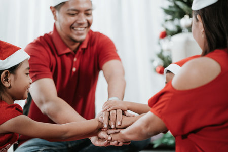 family put their hands together during christmas