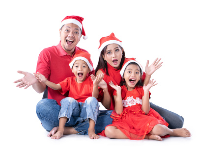 excited asian family with christmas headの写真素材