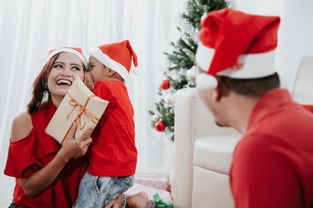 son say thank you by whispering to momの写真素材