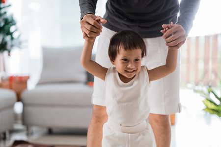 portrait of happiness little daughter try to walkingの写真素材