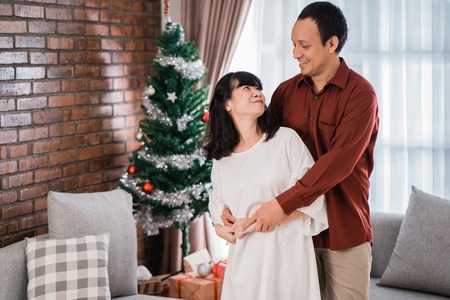 couple loving each other dancing during christmas dayの写真素材