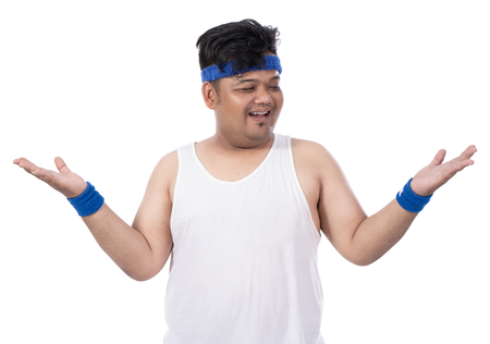 portrait of sporty fat young man raises his handsの写真素材