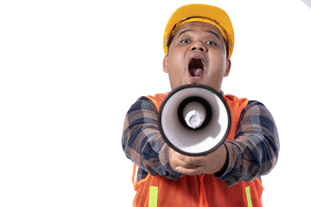 portrait of young handyman open her mouth and holding hornの写真素材