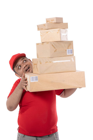 portrait of delivery man struggling to lift many boxes