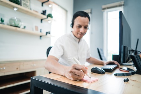 portrait of telecommunications workers writing complaintの写真素材