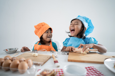 kids make some dough and cookies togetherの写真素材