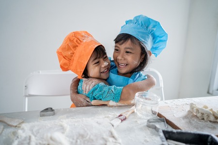 girl with apron making cookiesの写真素材