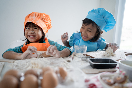 kids make some dough and cookies togetherの写真素材