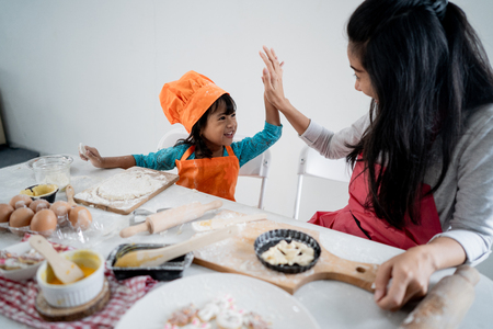 high five while making cake togetherの写真素材