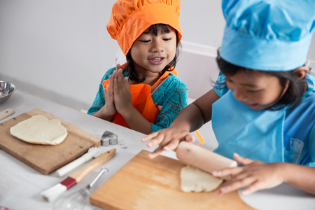 kids make some dough and cookies togetherの写真素材