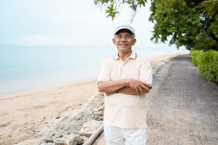 asian mature man smiling to cameraの写真素材