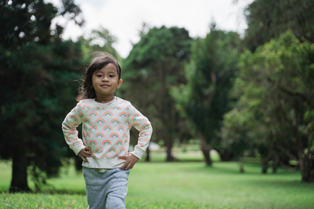 cute young kid walking in the parkの写真素材