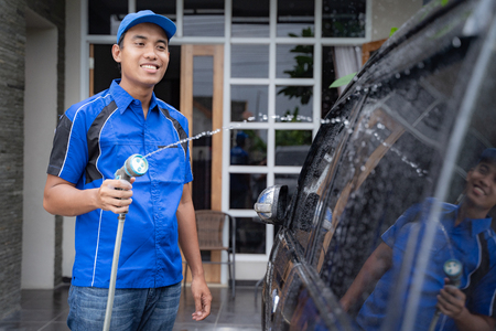 male car cleaning service worker washing black carの写真素材