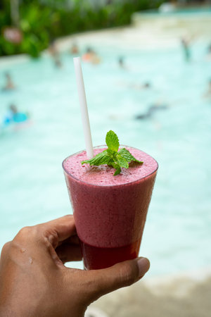 a glass of strawberry juice refreshment with mint
