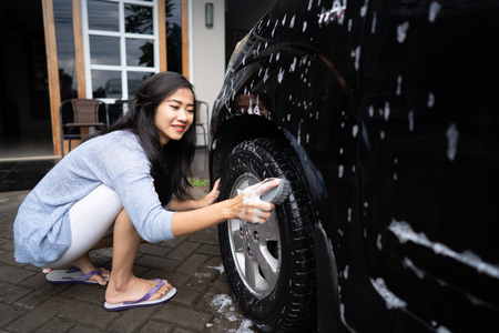 asian woman washing her carの写真素材