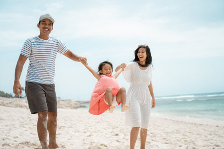 portrait happy family playing in the beach in the sunの写真素材