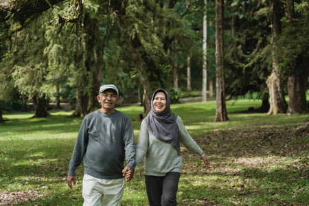 muslim senior couple walking in the garden togetherの写真素材