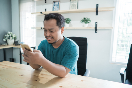portrait of smile businessman listen a good news with smartphoneの写真素材