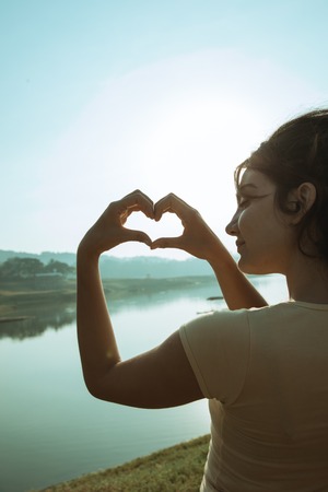 woman make a hearth shape in the morningの写真素材