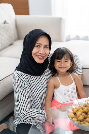 asian grandmother with granddaughter together smiling