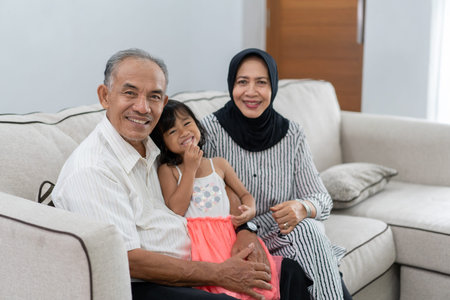 happy grandparent with their granddaughter looking at camera