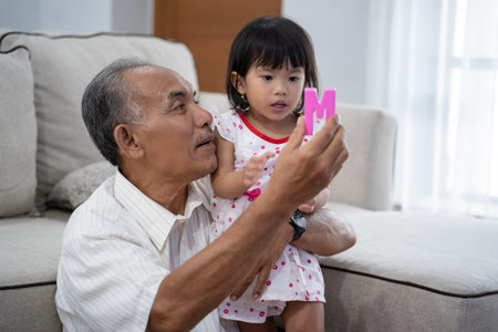 grandfather teaching his grandchildren about letter