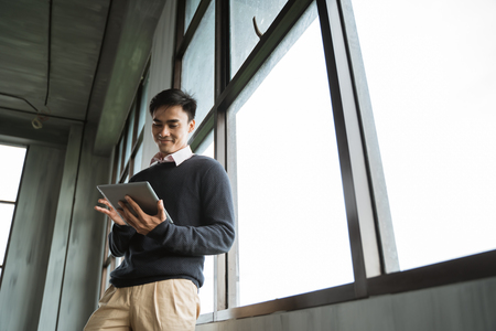 asian young businessman using tablet pcの写真素材