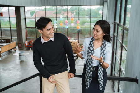 business people chatting in balconyの写真素材