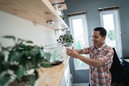 portrait a man worker is tidying up the shelvesの写真素材