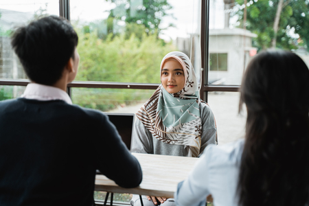 veiled women interviewed as new employees by two human resources departmentsの写真素材